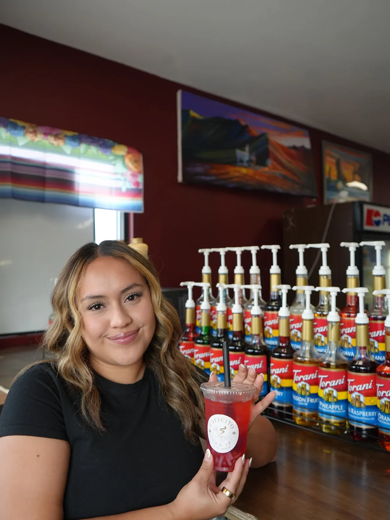 Karla, owner of Cafecito Con Fe, behind the counter in Mattawa